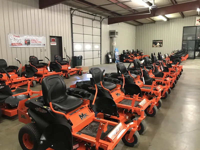 Hayes Equipment showroom lined with Bad Boy zero turn mowers, a Honda generator banner and Snapper sign