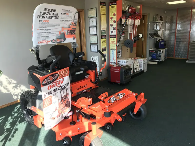 Bad Boy Outlaw mower beside Honda EU3000is and Yamaha EF2000iS generators in the Hayes Equipment showroom