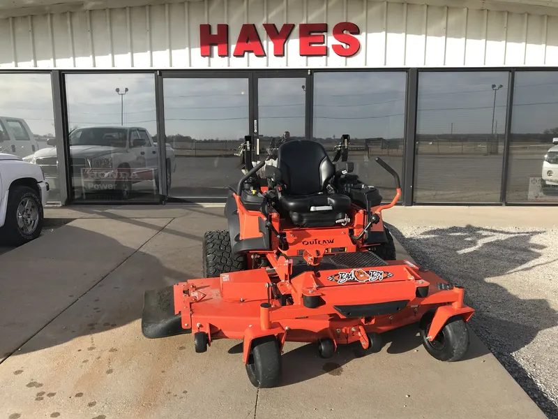 Hayes Equipment storefront with red HAYES sign, company truck and a Bad Boy Outlaw zero turn mower