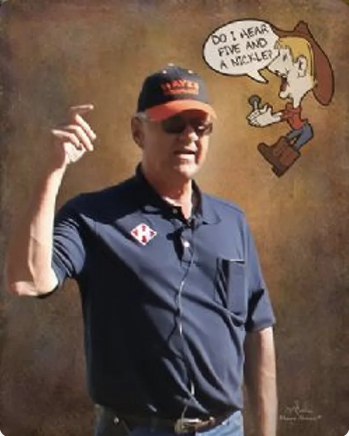 John B. Hayes, Ponca City auctioneer, in a Hayes cap and shirt with a cartoon auctioneer asking Do I hear five and a nickel